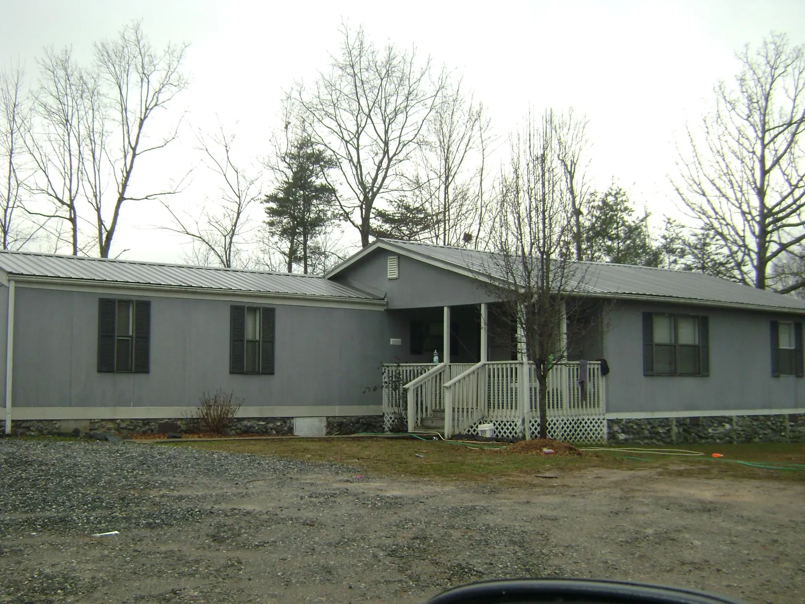 Metal roof over a manufactured home with a covered front porch in Westhampton
